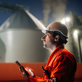  Petroleum Engineer using digital tablet at night.