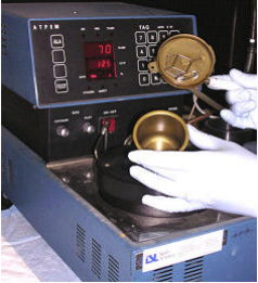 Flash Point Tester and white-gloved hands