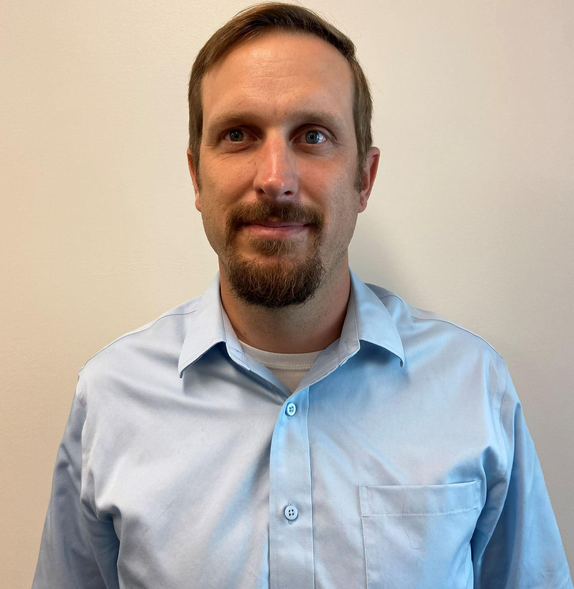 Martin Schmidt headshot- white man with brown hair and beard wearing a blue oxford shirt