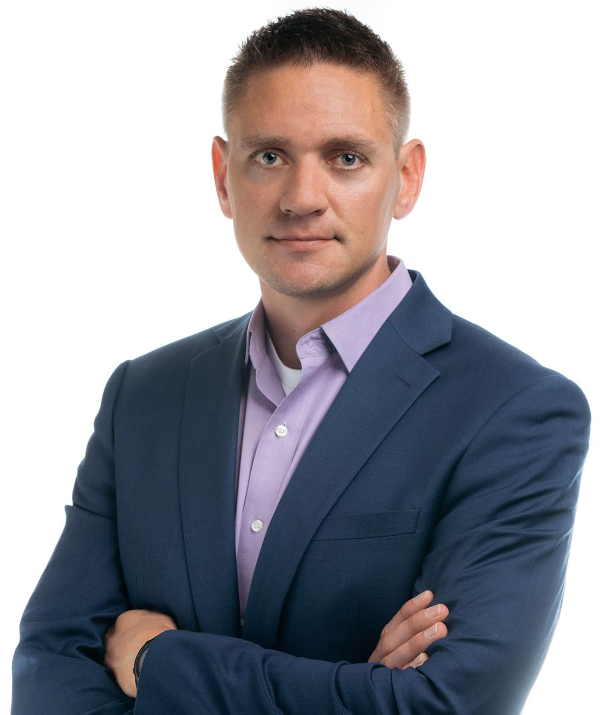 Scott Wendland headshot- Man with short hair, dark blue suit and lavender shirt