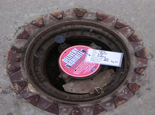 An oil delivery access point with a delivery prohibition tag. 