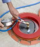 A vacuum testing spill bucket